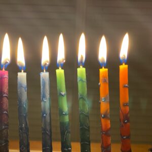 Lit colourful candles in a menorah