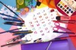 a rainbow-colored poster of the aleph-bet is surrounded by children's art supplies